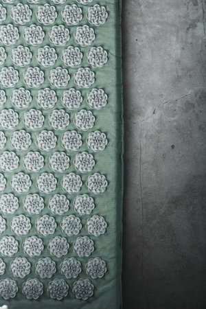 Massage mat with prickly spikes Kuznetsov applicator top view. On a gray background with free spaceの写真素材