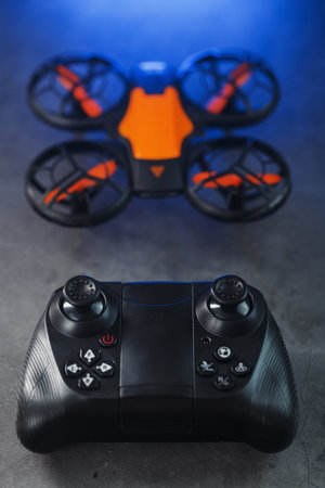 Quadcopter drone with joystick control and blue neon backlight, on a dark textured background