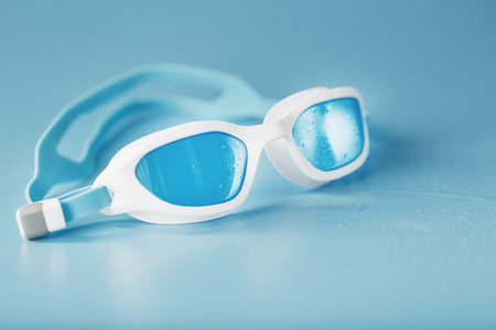 Swimming goggles in a white frame with a blue filter on a blue backgroundの写真素材
