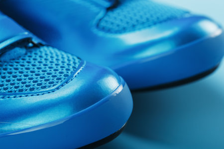 Blue highway cycling shoes on a blue backgroundの写真素材