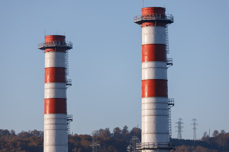 Power plant with two red and white pipesの写真素材