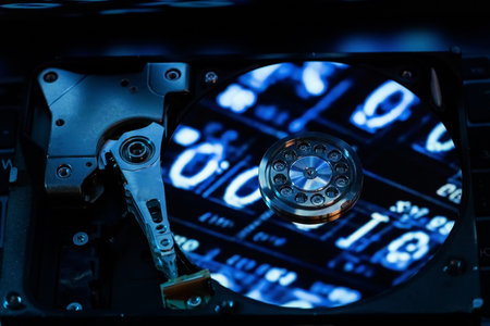 A hard disk with a blue binary codeの写真素材