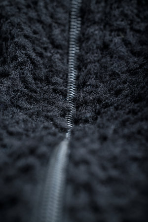 Zipper on black fleece background close-upの写真素材