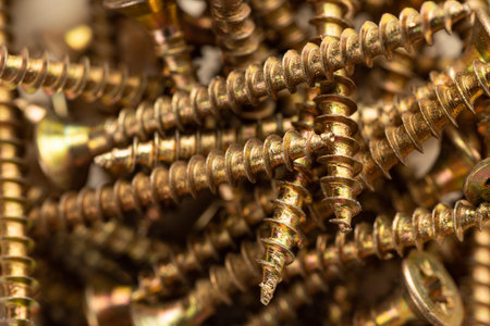 Texture of a pile of wood screws, full screen macro