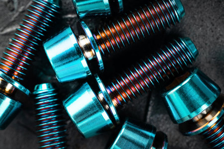Titanium bolts on a black textured background