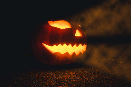 Halloween Pumpkin on a foggy mysterious scary night sceneryの写真素材