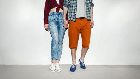 beautiful couple standing by the wall