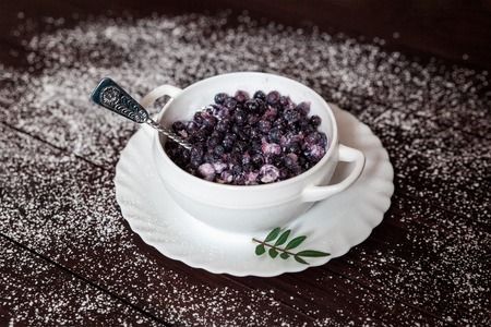 Blueberries and ice cream in the white plateの写真素材