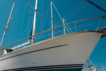 nose of white beautiful moored sailboat in the sea port