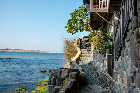 sea view with stone wall and stairway in sozopol, bulgariaの写真素材