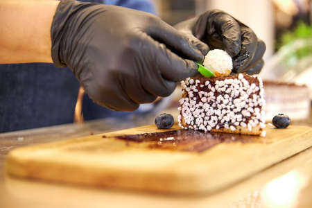 a piece of chocolate cake decorated with white coconut ballsの写真素材