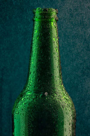 Cold beer bottle with drops under spray close-upの写真素材