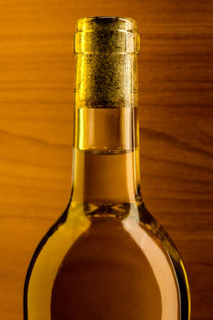 Bottle of white wine on the surface of a wooden background の写真素材
