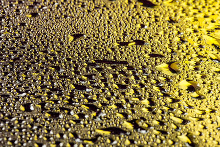Water drops on gold surface like quicksilverの写真素材