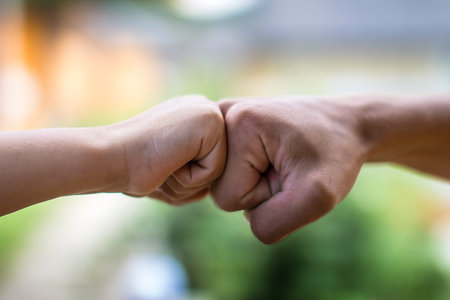 Two fists on blurred background