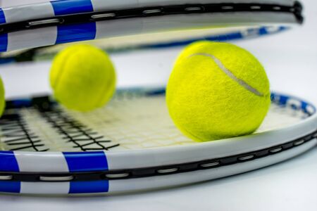 tennis ball and racket on white backgroundの写真素材