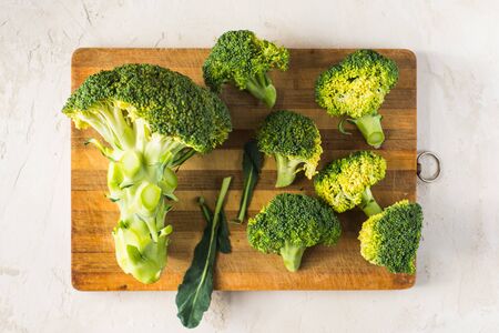 fresh broccoli on a wooden boardの写真素材