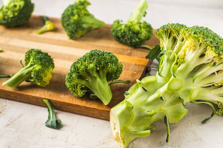 fresh broccoli on a wooden boardの写真素材
