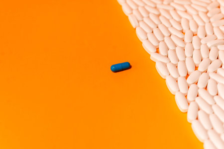 blue and white pills on orange abstract background
