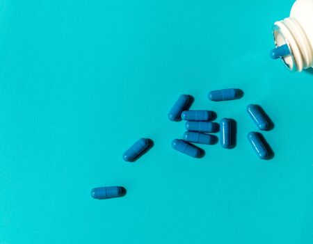 blue pills on color backgroundの写真素材
