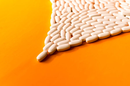 white pills on orange abstract background