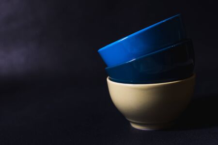 colored bowls for food on a dark backgroundの写真素材
