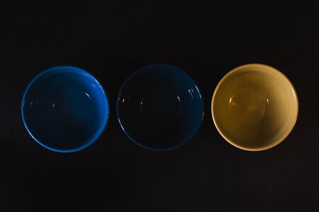 colored bowls for food on a dark backgroundの写真素材