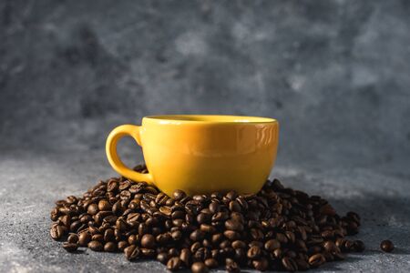 cup of coffee with beans on gray stone backgroundの写真素材
