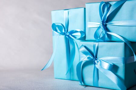 present box with blue bow isolated on gray backgroundの写真素材