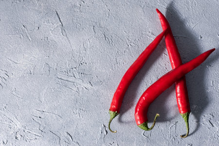 red hot chili peppers on a gray stone background