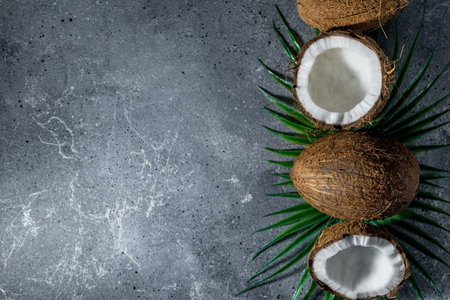 ripe chopped coconut on a gray stone background.