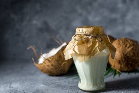 ripe chopped coconut on a gray stone background with Coconut milk.の写真素材