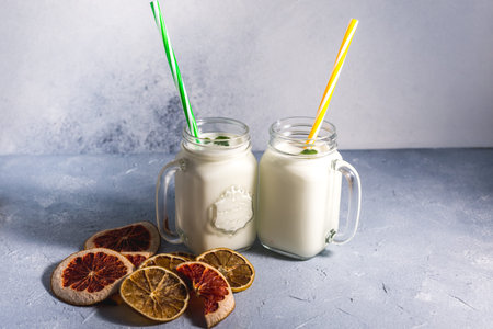 simple homemade kefir in a glass with spices and herbs on a gray background, copy space. Probiotic Ayranの写真素材