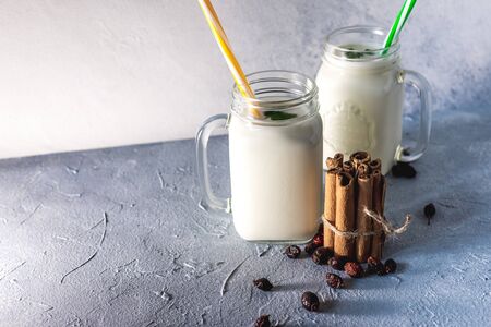 simple homemade kefir in a glass with spices and herbs on a gray background, copy space. Probiotic Ayranの写真素材