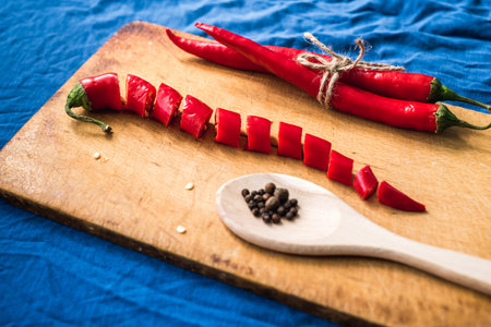 Red chili peppers close-up on classic blue background copy space