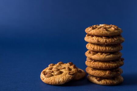homemade healthy cookies with roasted peanuts on a blue background with place for your textの写真素材