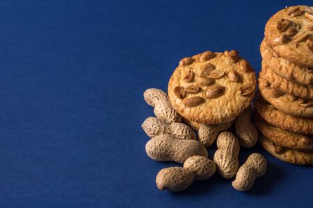 homemade healthy cookies with roasted peanuts on a blue background with place for your textの写真素材