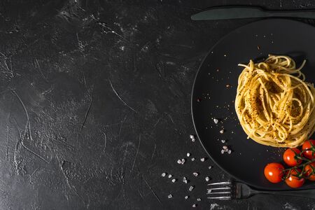 fragrant Italian spaghetti pasta with tomato sauce and cheese and healthy spices served on a dark background Top view.の写真素材