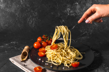 fragrant Italian spaghetti pasta with tomato sauce and cheese and healthy spices served on a dark background Top view.の写真素材