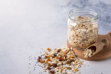 Bowl with useful oatmeal on a light background. The concept of cooking oatmeal. healthy food. dietの写真素材