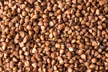healthy buckwheat in a bowl isolated on gray background close-up with place for textの写真素材