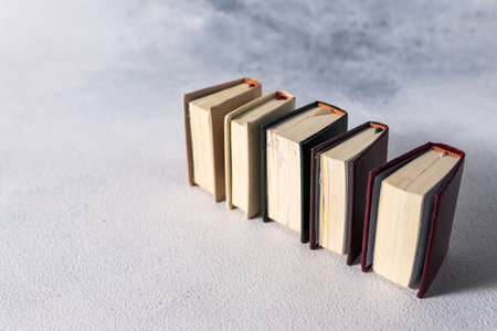 A stack of old little books. Shabby pages, damaged book covers.の写真素材