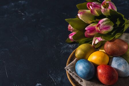 Multi-colored bright easter eggs. Easter eggs on a dark background symbol. Christ is risen copyspace close-upの写真素材