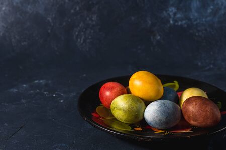 Multi-colored bright easter eggs. Easter eggs on a dark background symbol. Christ is risen copyspace close-upの写真素材
