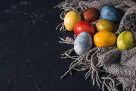 Multi-colored bright easter eggs. Easter eggs on a dark background symbol. Christ is risen copyspace close-upの写真素材