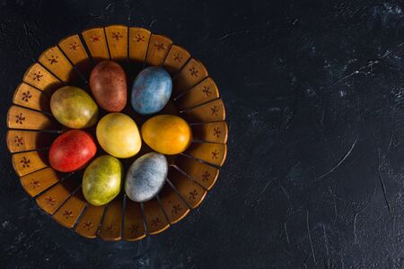 Multi-colored bright easter eggs. Easter eggs on a dark background symbol. Christ is risen copyspace close-upの写真素材
