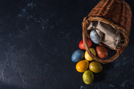 Multi-colored bright easter eggs. Easter eggs on a dark background symbol. Christ is risen copyspace...