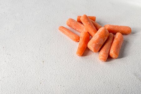 Bunch of fresh healthy carrots vitamins on a light gray backgroundの写真素材