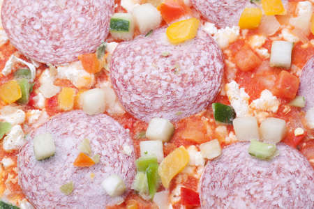 Frozen pizza with salami and vegitablesの写真素材