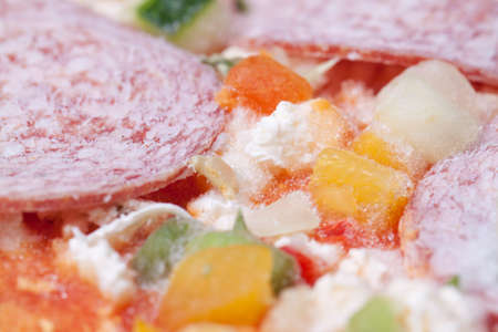 Frozen pizza with salami and vegitablesの写真素材